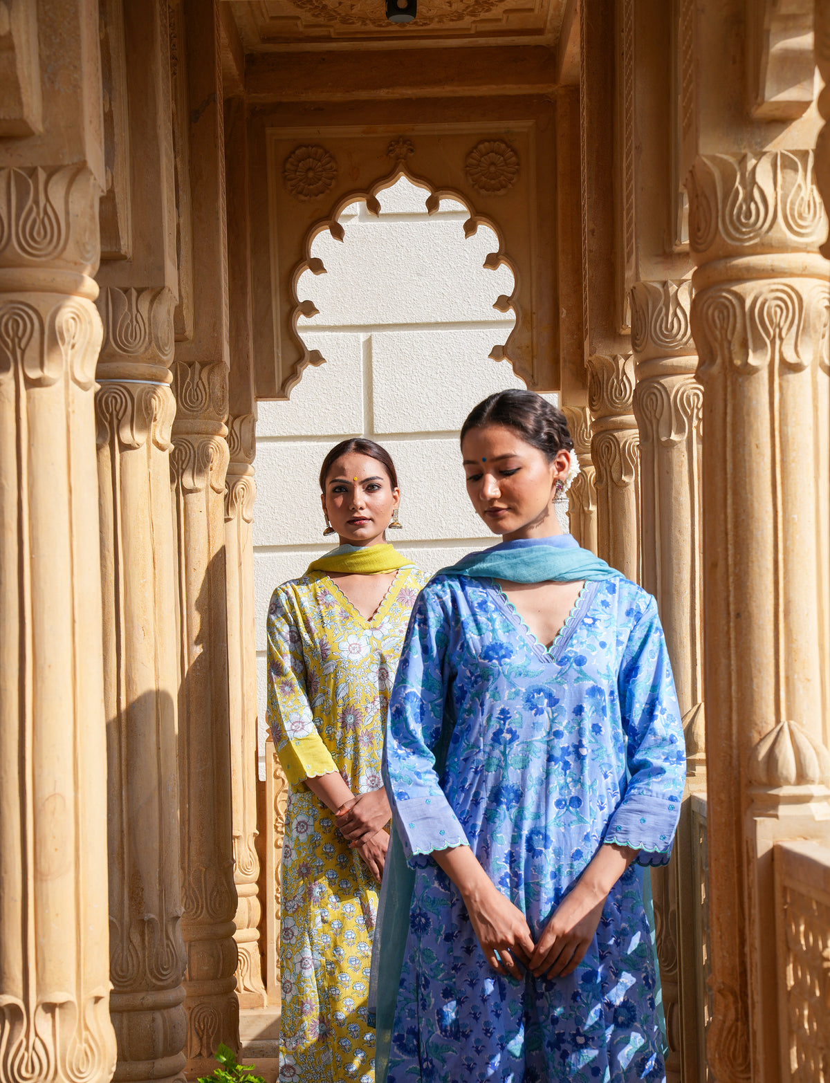 Hand block printed blue floral kurta set, photographed in the sandstone arches of Rajasthan