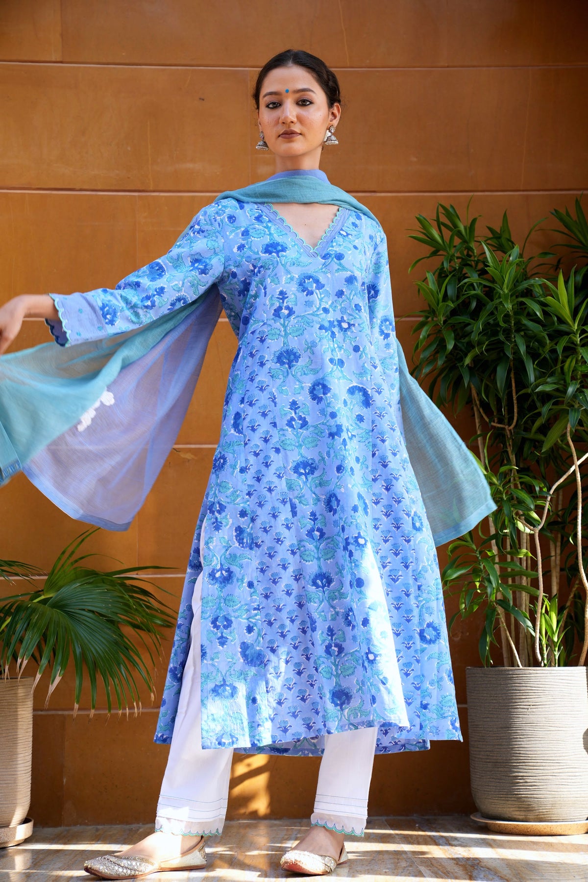 Hand block printed blue floral kurta set, photographed in the sandstone arches of Rajasthan