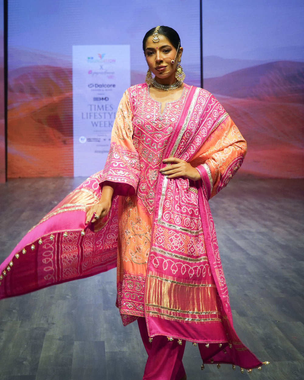 A model in a pink lehenga from Ada-E-Hind on the runway at Times Lifestyle Week 2026